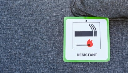 Label on the cushion of furniture showing the fabric has been treated to make it fire resistant