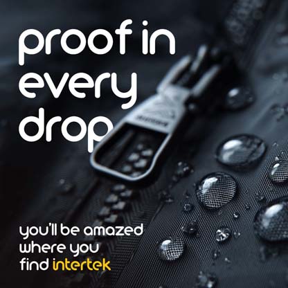 A closeup of water beading on a garment next to a zipper